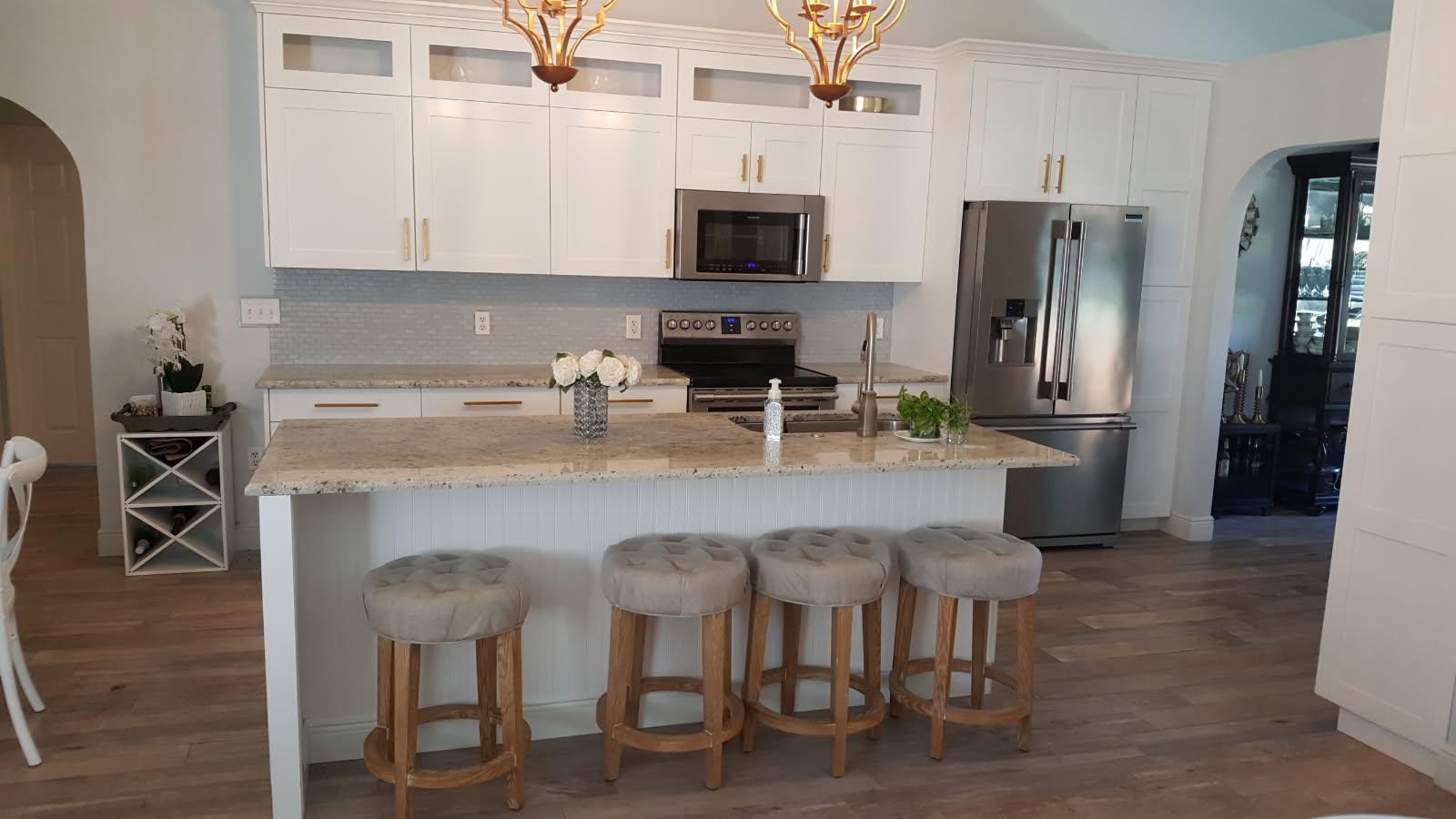 Custom kitchen remodel — white shaker cabinets, granite island, hardwood floors