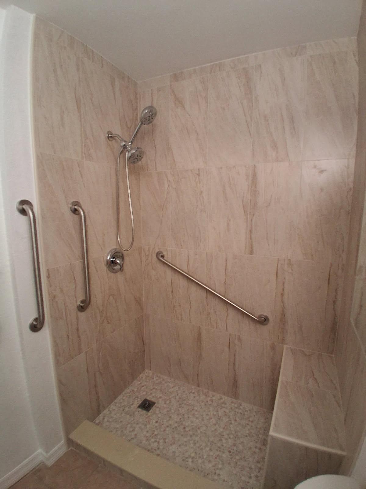 Walk-in shower with large-format marble tile and grab bars